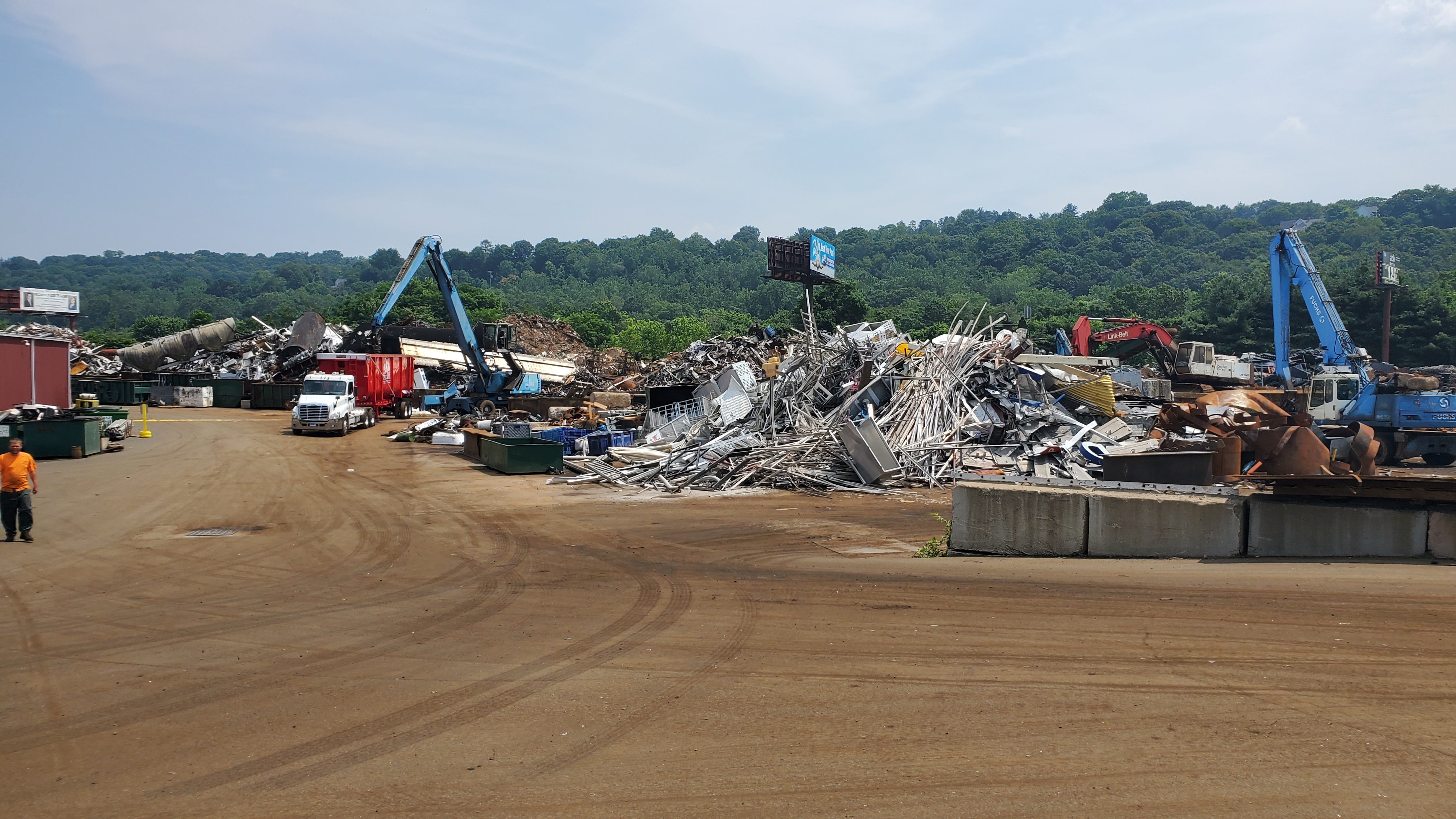 Industrial scrap yard with heavy material handling equipment